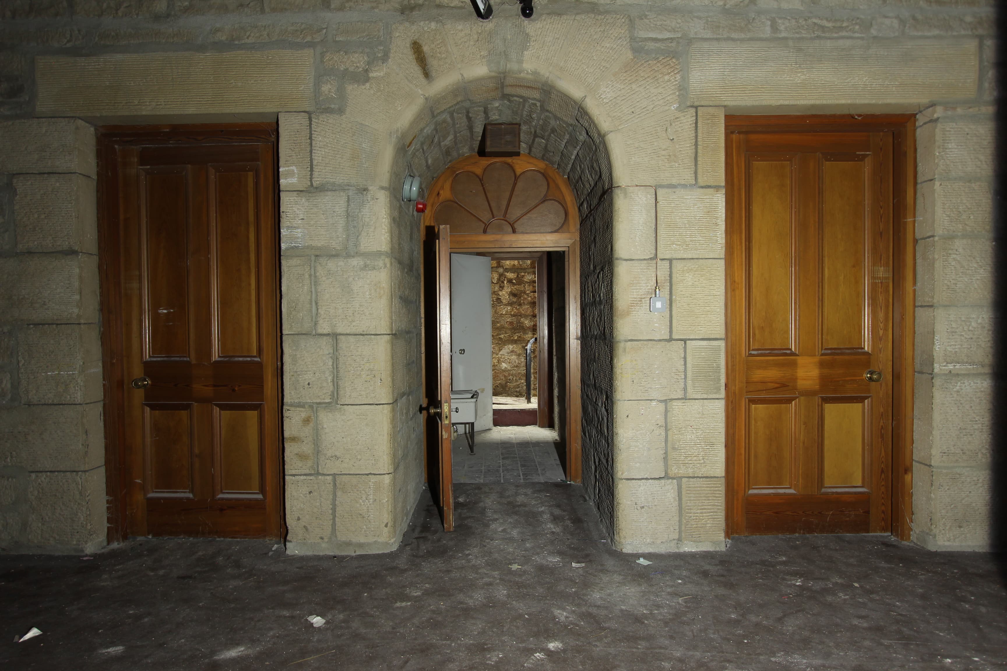 Underground doorways, three wooden doors, one open